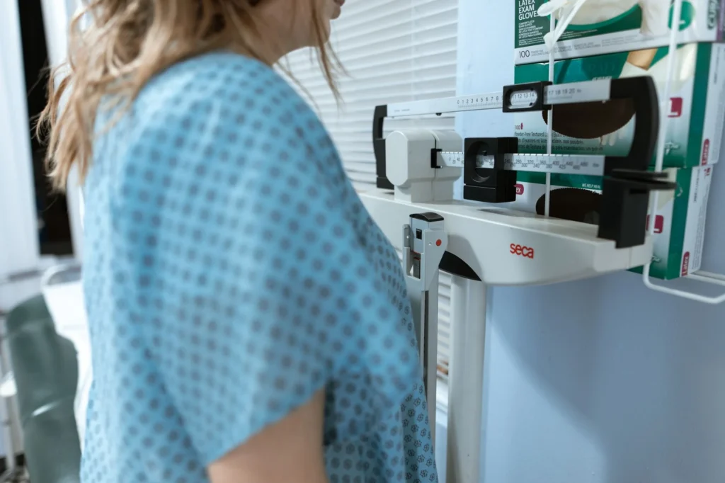 adjusted body weight calculator – healthcare professional reviewing patient weight and clinical data