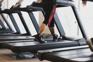 person walking on treadmill – fitness walking exercise for calorie burning and weight loss