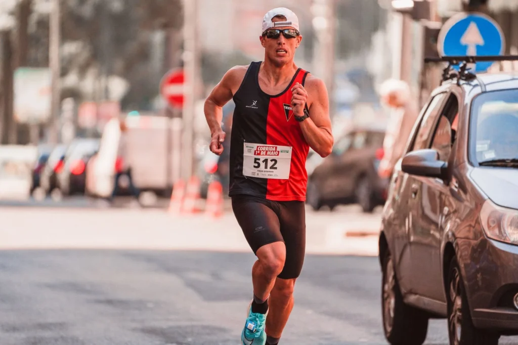 Runner competing in a 5K race on urban streets burning calories