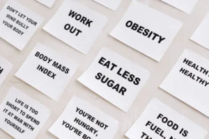 how to lower bmi – person exercising and tracking weight loss progress for fitness goals