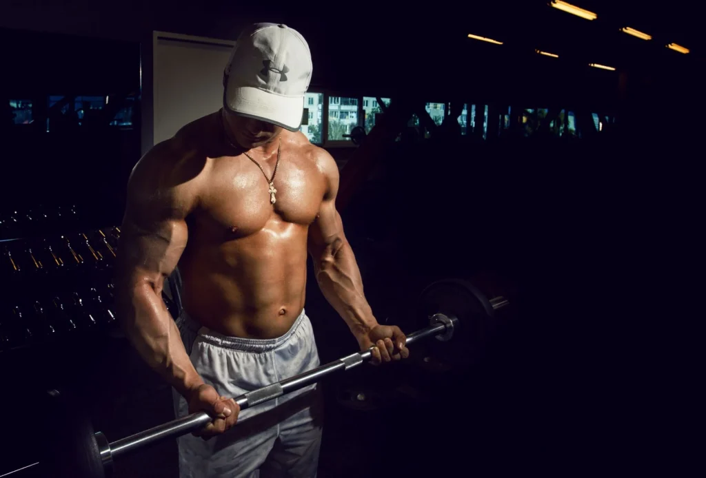 Recomposition method – person training with weights at the gym for muscle building and fat loss