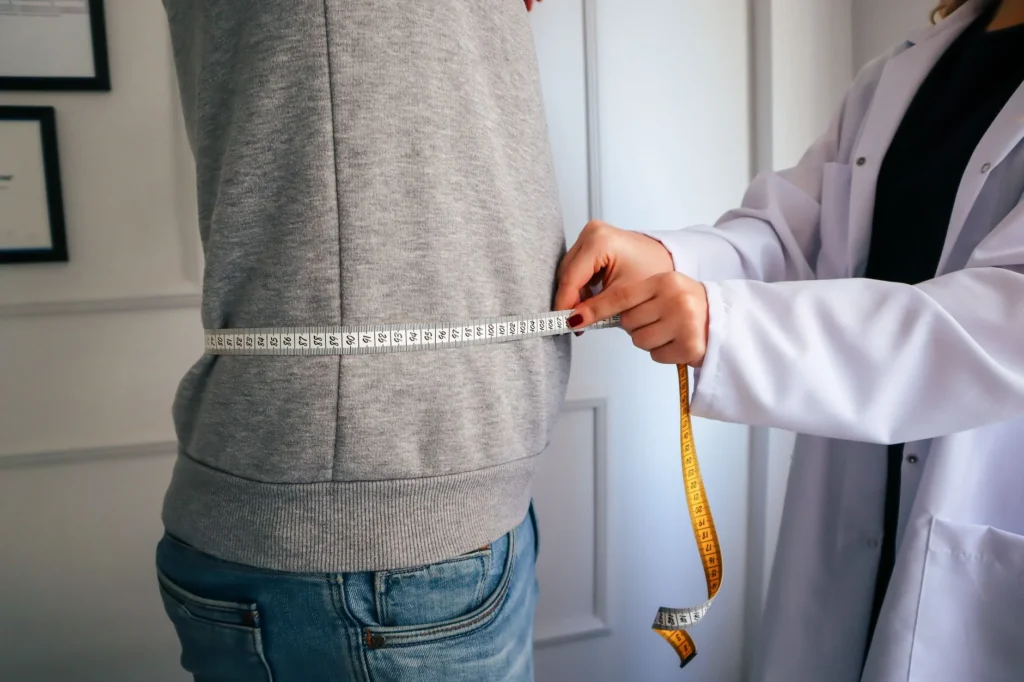 reverse BMI calculator – person stepping on a scale to track weight progress toward a BMI goal