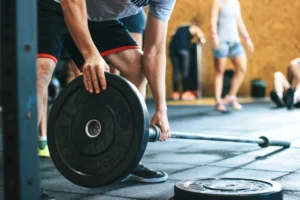 What weight is considered skinny – person holding a barbell at the gym showing fitness and healthy weight