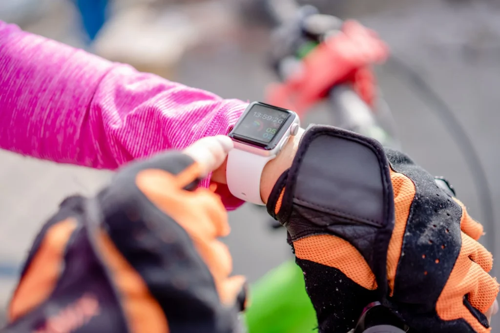 Cyclist checking Apple Watch activity rings outdoors