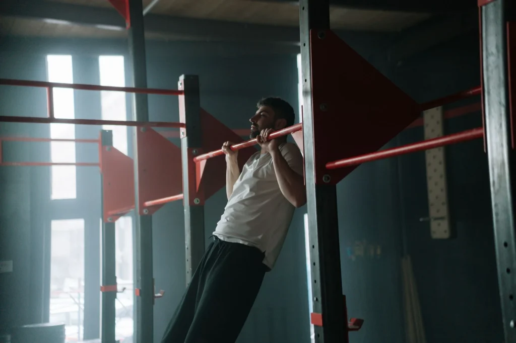 Person doing pull-ups on a bar – training exercise for building upper body strength