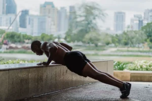 push-ups fitness – person doing push-ups on a gym floor demonstrating proper form for fitness