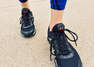Steps per day goal – close-up of athletic sneakers walking outdoors for fitness tracking