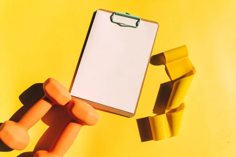 workout plan template – person writing a structured training schedule in a notebook