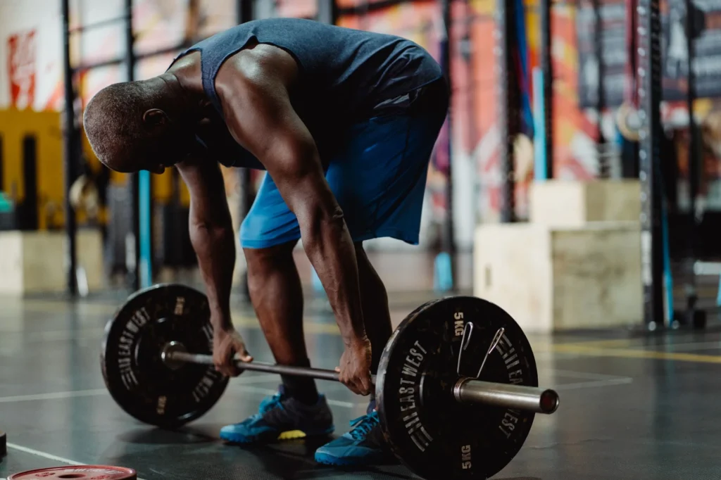Man performing a deadlift in the gym as part of a workout routine for men