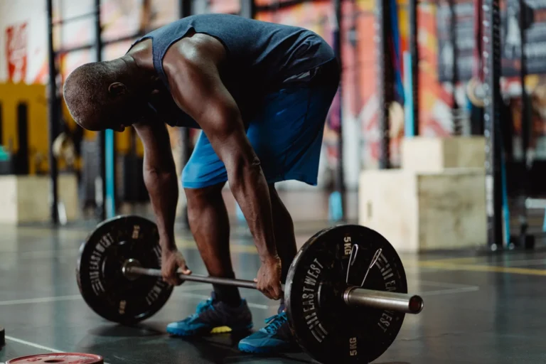 Man performing a deadlift in the gym as part of a workout routine for men
