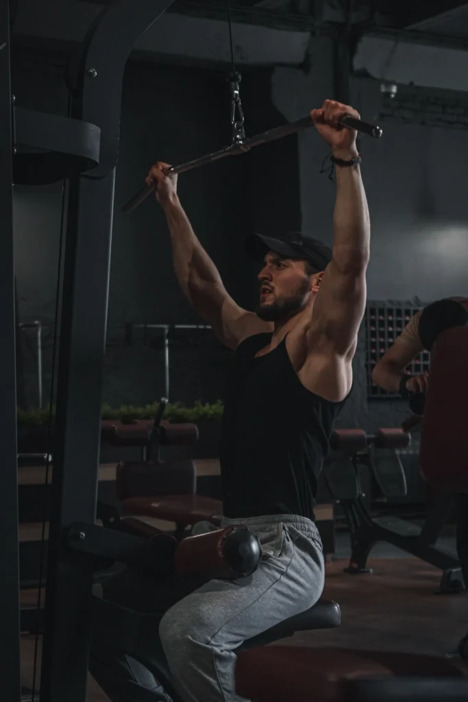 Man performing a lat pulldown exercise targeting the latissimus dorsi muscles