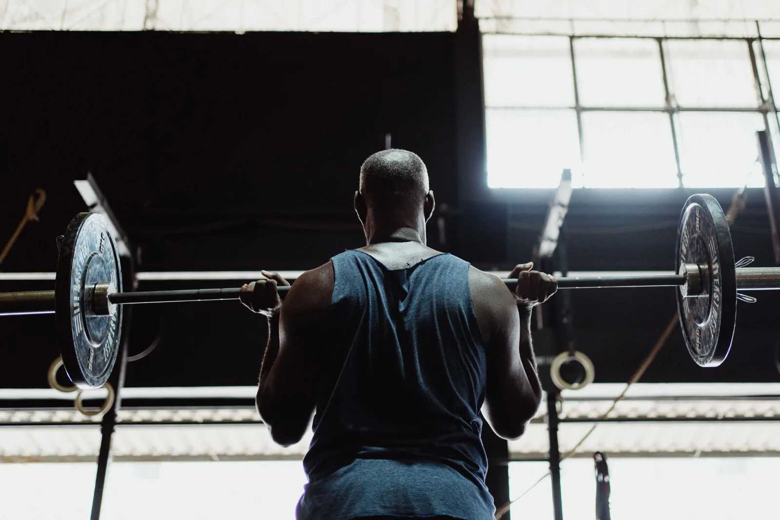 Man lifting a barbell during weight training in the gym